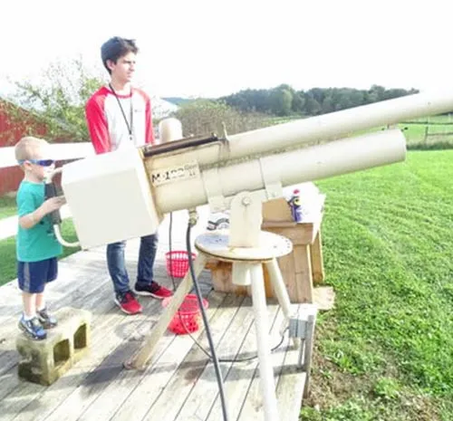 Adult supervises as small boy fired the Apple Canon at Ellms Farm