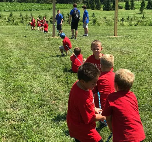 Kids in red shirts playing tug-of-war at Ellms Family Farm in Saratoga