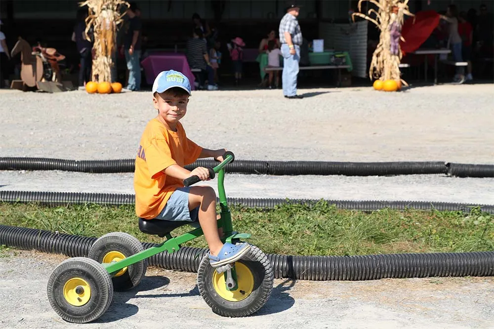 boy riding tricycle