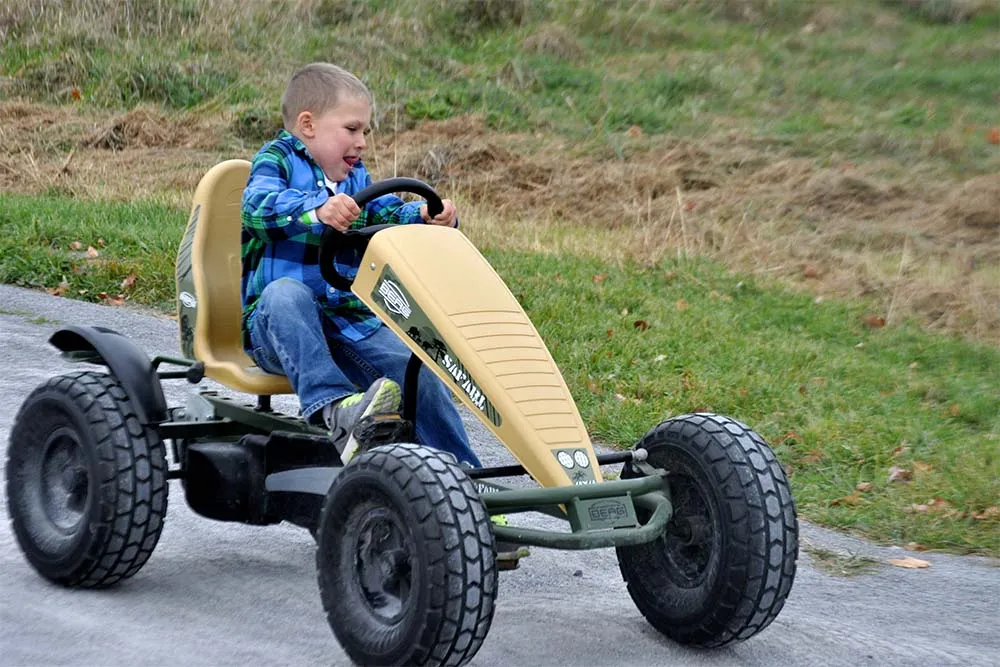 kid driving a pedal cart