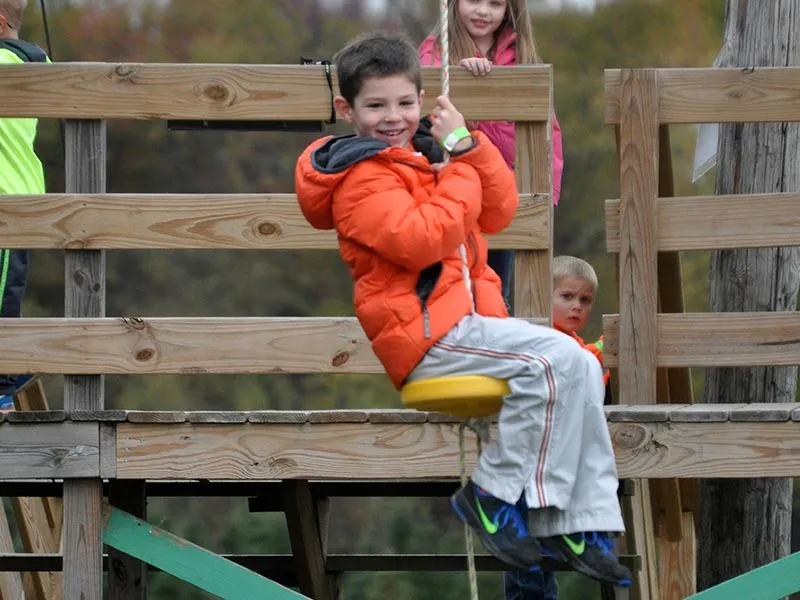 Smiling boy ziplining