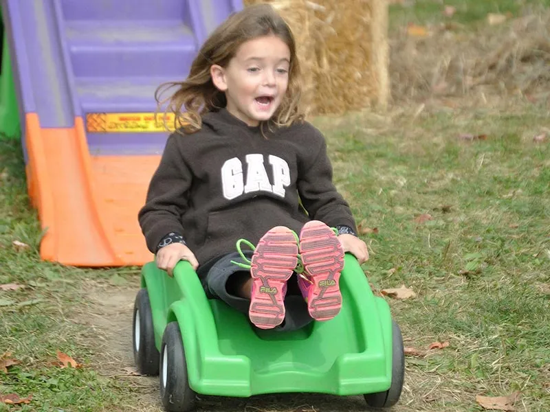 Girl riding rollercoaster at Ellms Farm